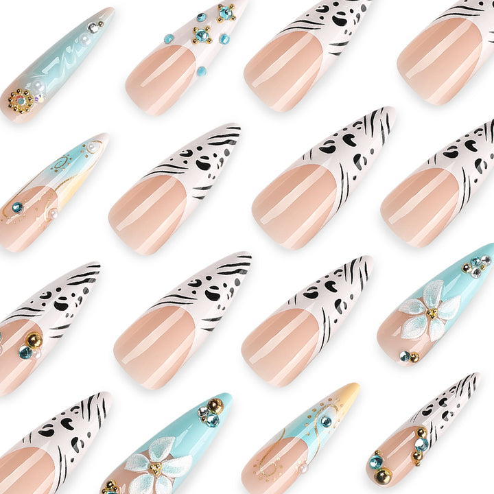 Kunstvolle Stiletto-Nägel mit floralen Akzenten und Glitzerdetails Karnz