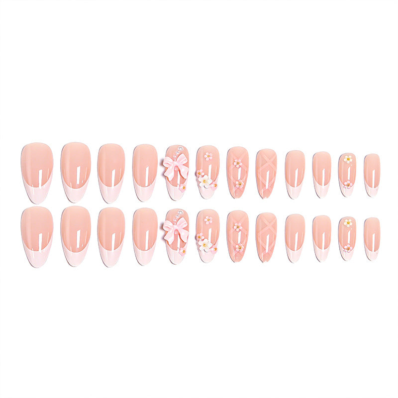 Kunstvolle Nagelspitzen mit Schleifen und Blumendekoren Karnz