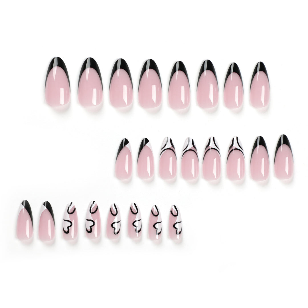 Kunstvolle Stiletto-Nägel mit elegantem Schwarz-Weiß-Design Karnz