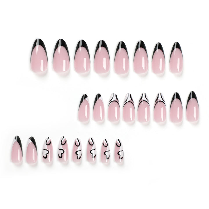 Kunstvolle Stiletto-Nägel mit elegantem Schwarz-Weiß-Design Karnz