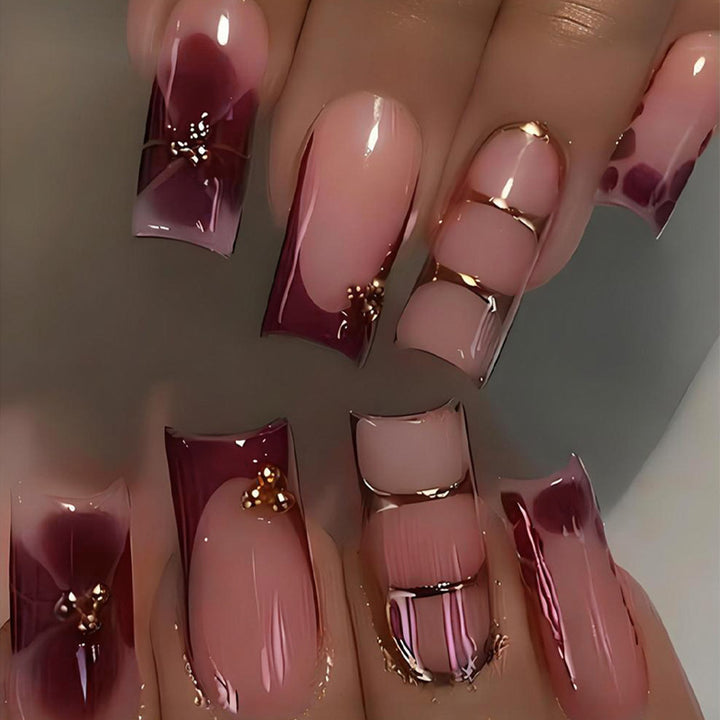 Kunstnagelset mit eleganten Farbverlauf und filigranen Verzierungen Karnz