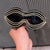 Damen Glamouröse Wellen-Sonnenbrille mit funkelnden Kristall-Applikationen Karnz
