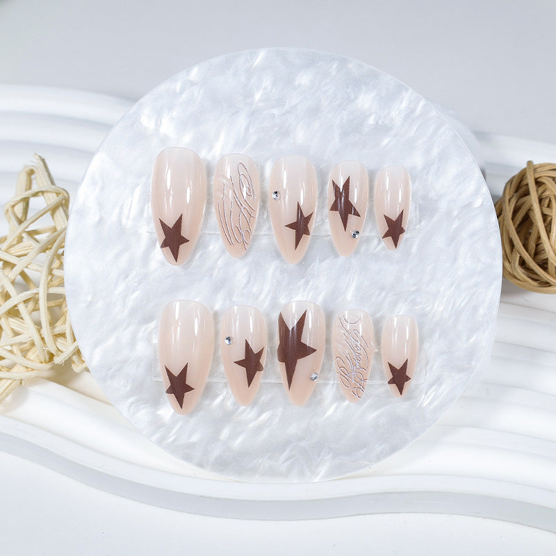 Kunstnagelset mit eleganten Sternenmotiven und Glitzerakzenten Karnz