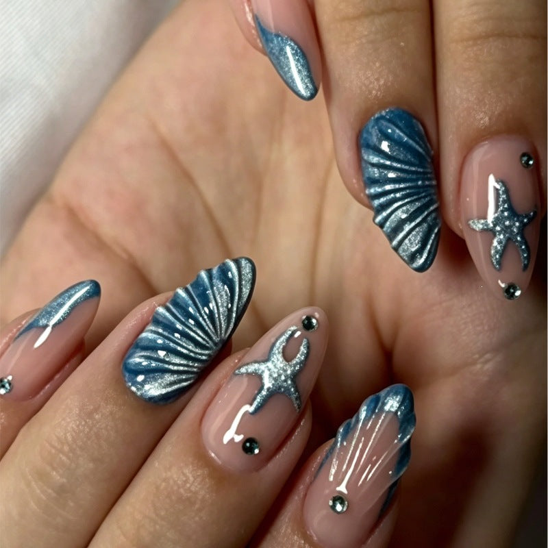 Kunstnagelset mit maritimen Muschel- und Sternmotiv Karnz