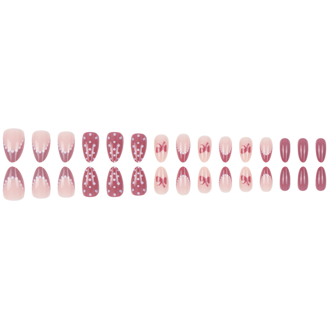 Künstlerisches Press-On-Nagelset mit Schleife und gepunktetem Design Karnz