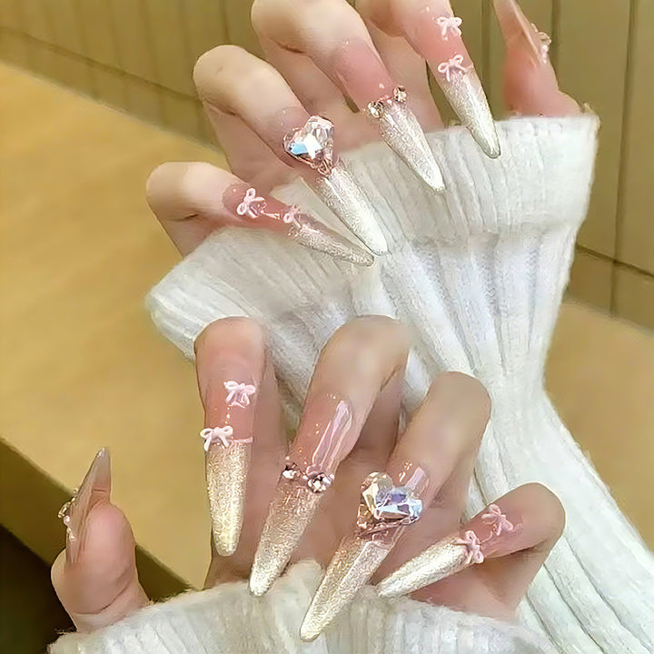 Kunstnagelset mit funkelnden Spitzen und zarten Schleifenverzierungen Karnz