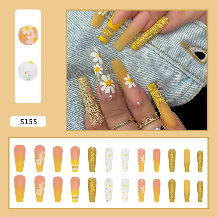 Kunstnagelset mit bunten Sonnenblumenmotiven und glitzernden Akzenten Karnz