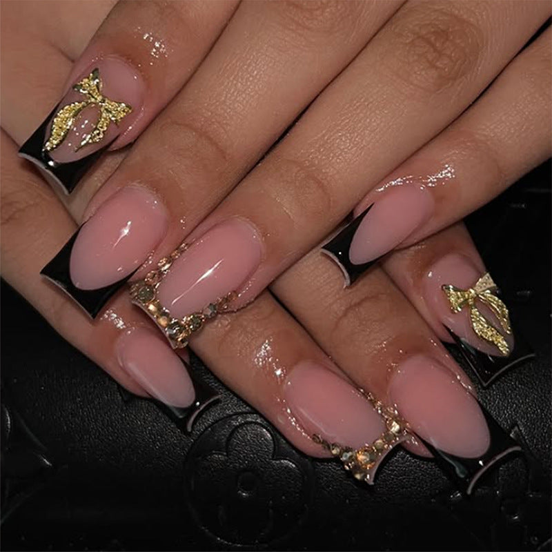 Kunstnagelset mit eleganter Goldverzierung und stilvollem Schwarz Karnz