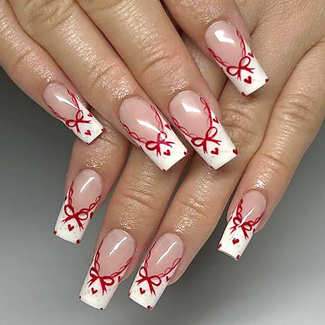 Dekoratives Langes Press-On-Nagelset mit Schleifen- und Herzdesign Karnz