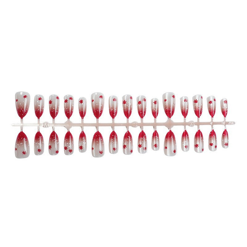 Kunstnagelset mit elegantem Rot-Ombré-Look und zarten Ahornblättern Karnz