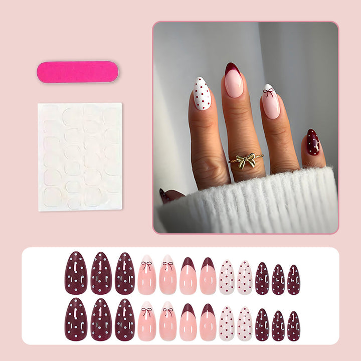 Kunstnagelset mit eleganten Schleifen- und Punktemotiven Karnz
