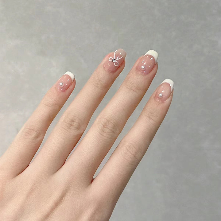 Dekorativer French Tip Press-On Nail Set mit Schleifenakzenten Karnz