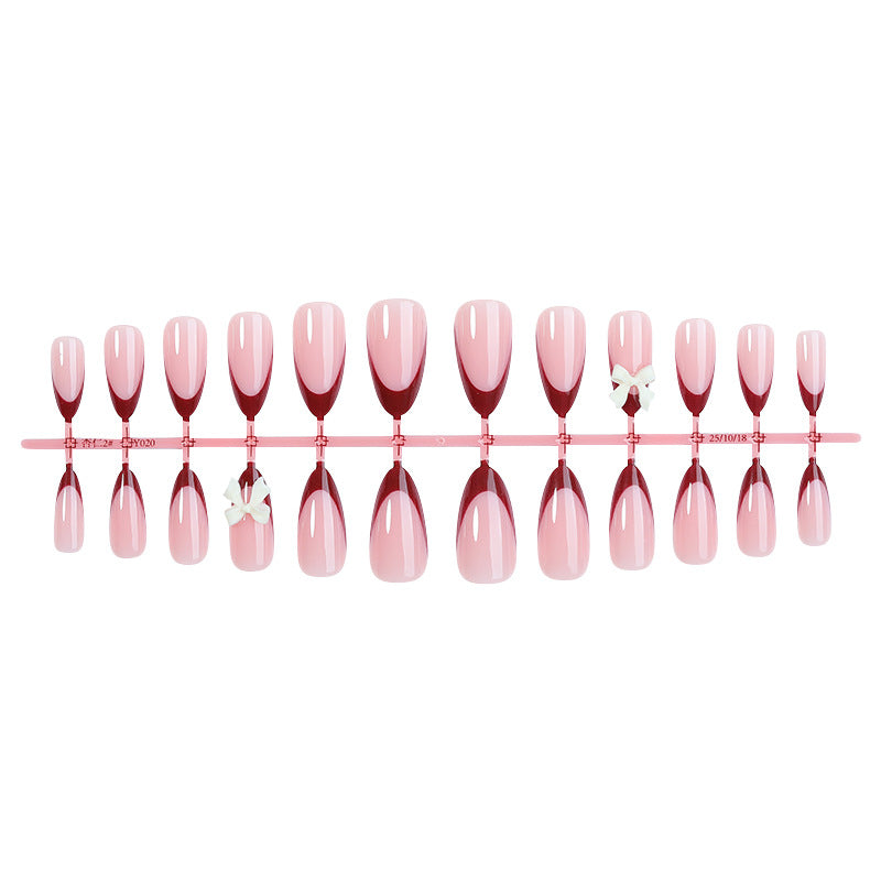Kunstnagelset mit kreativem French-Tip Design und niedlichen Schleifen Karnz