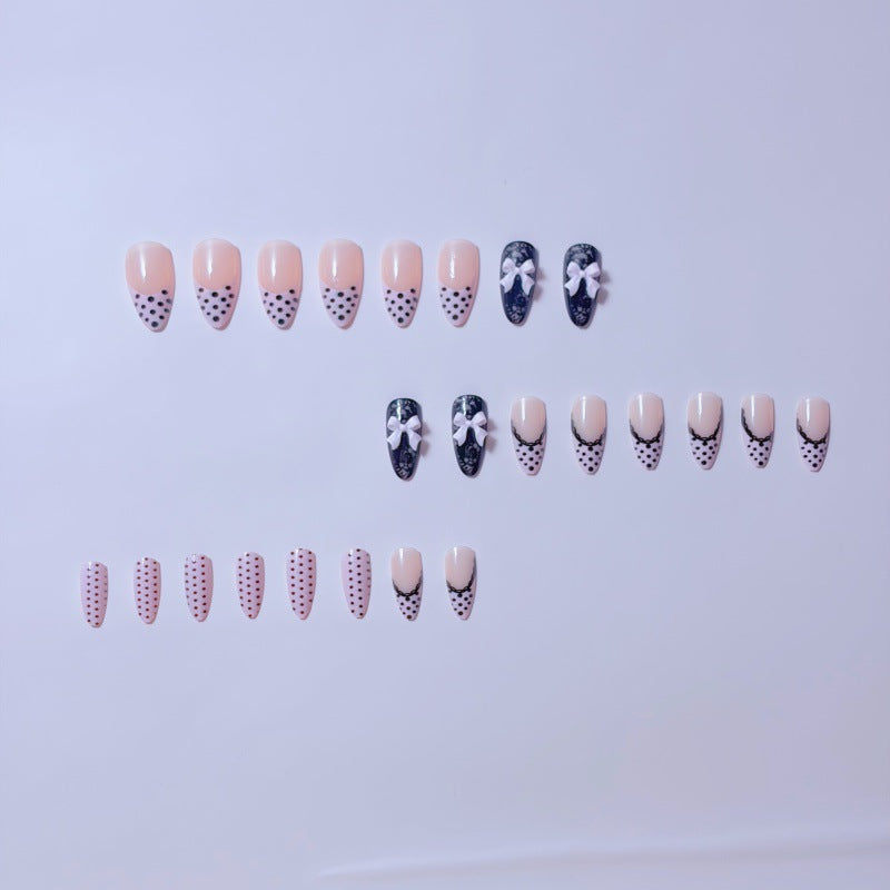 Elegante Kunstnägel mit Spitzendesign und Schleifenakzenten Karnz