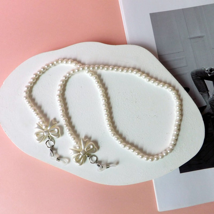 Elegante Perlen-Brillenkette mit Schleifenanhängern Karnz