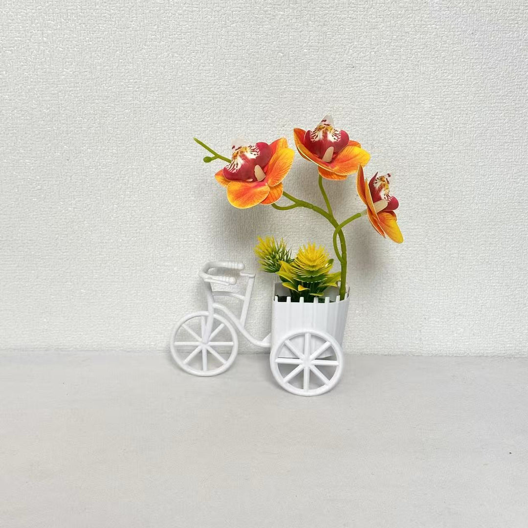 Dekorativer Fahrrad-Blumentopf mit Kunstorchideen-Arrangements für Dekor
