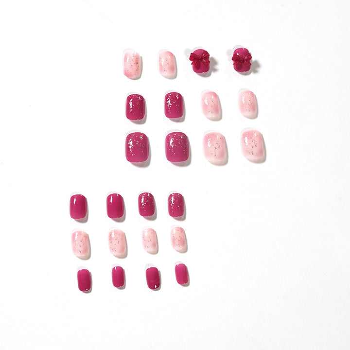 Künstliche Nagelkunst mit Glitzerverzierungen und niedlichem Schleifenmotiv Karnz