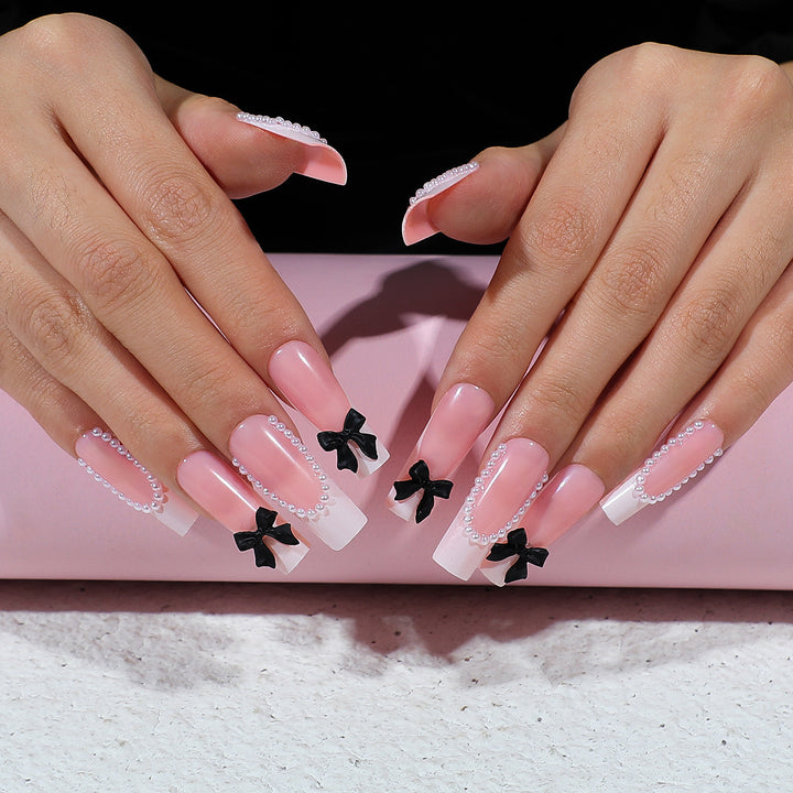 Kunstnagelset mit eleganten Strass- und Schleifenverzierungen Karnz