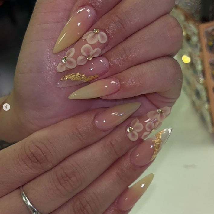 Kunstnagelset mit filigranen Blütenverzierungen und elegantem Glanz Karnz