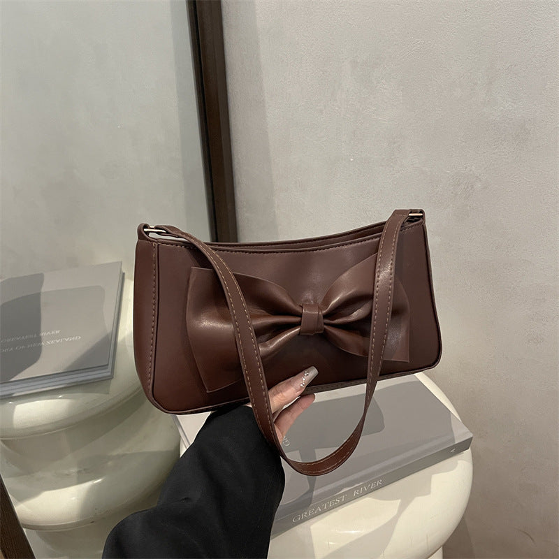 Elegante Clutch mit Schleifen-Detail für den Abend