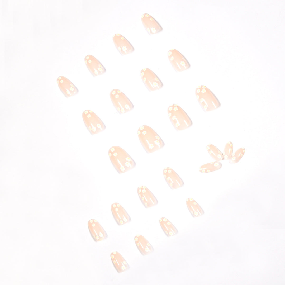 Künstliche Nagelkunst mit floralem Design und Glitzerakzenten Karnz