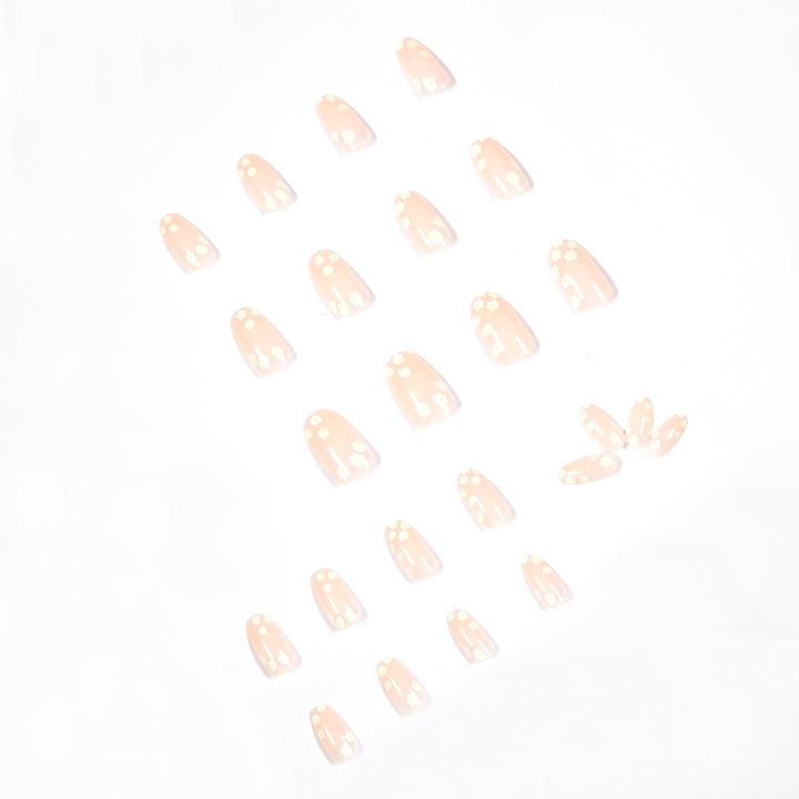 Künstliche Nagelkunst mit floralem Design und Glitzerakzenten Karnz