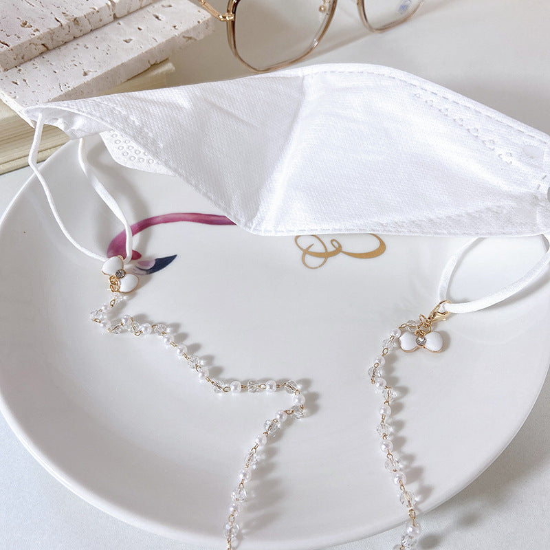 Elegante Ohrringe mit Perlen und Blütenanhängern Karnz