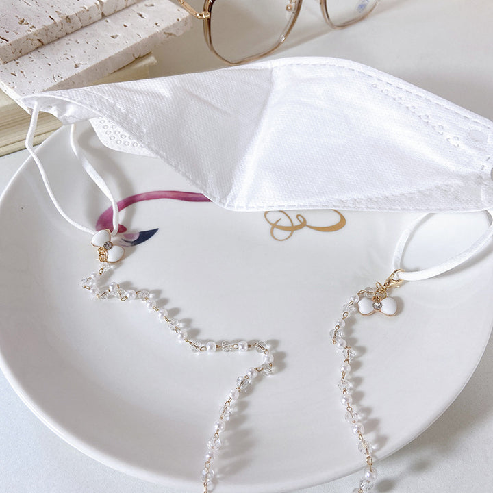 Elegante Ohrringe mit Perlen und Blütenanhängern Karnz