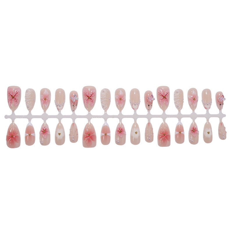 Kreatives Kunstnagelset mit filigranen Blüten- und Glitzerverzierungen Karnz