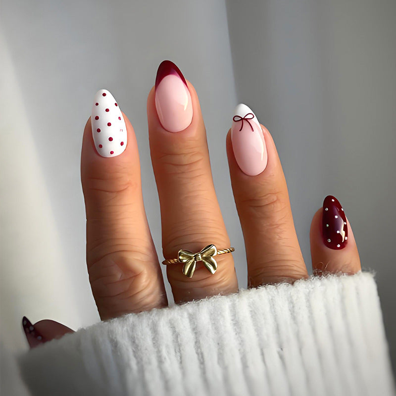 Kunstnagelset mit eleganten Schleifen- und Punktemotiven Karnz