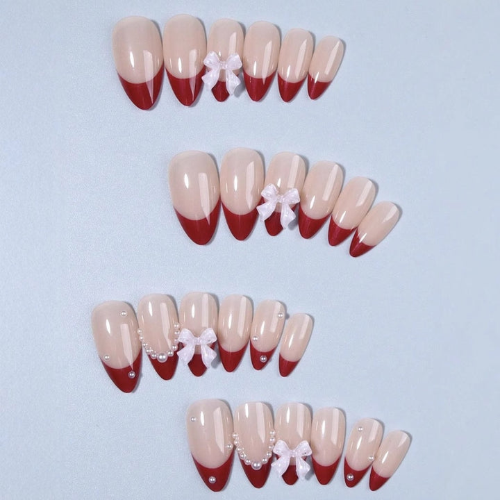 Kunstnagelset mit glamourösen Strass- und Schleifenverzierungen Karnz