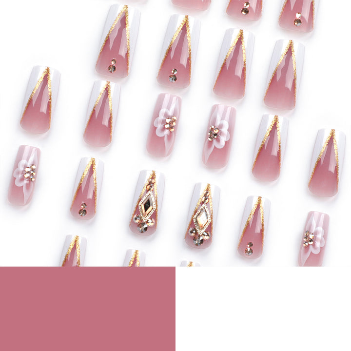 Kunstvolle Nagelverlängerungen mit Blumen- und Glitzerakzenten Karnz