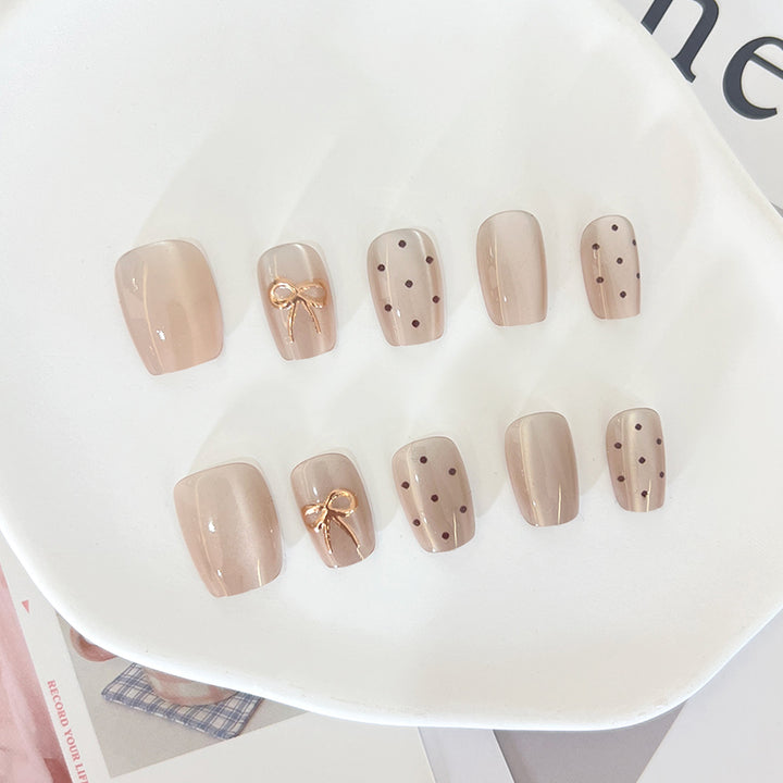 Künstliche Nagelspitzen mit eleganten Schleifenmotiven Karnz
