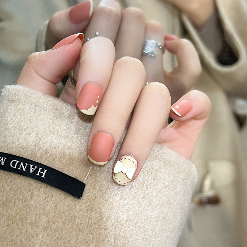 Kunstvolle Nagelnägel mit dekorativen Bogenmotiven und French-Spitzen Karnz