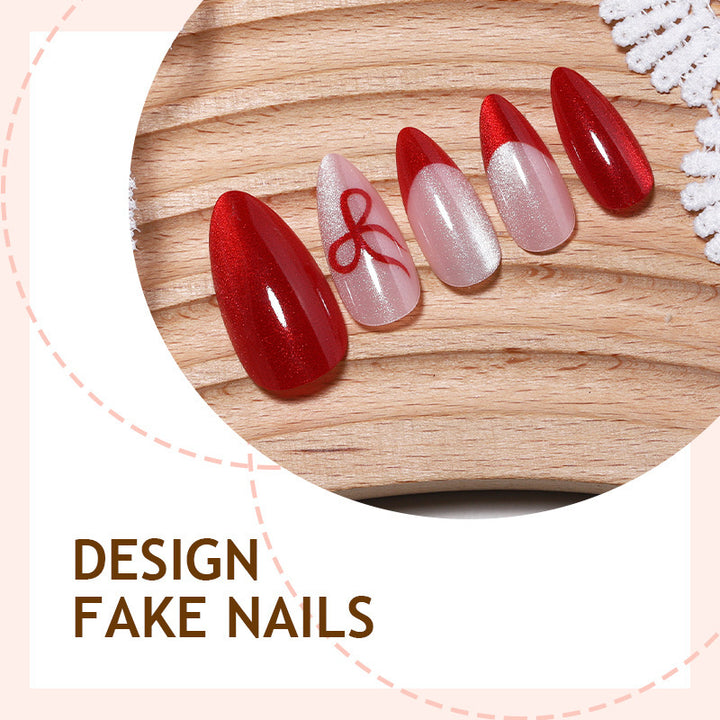 Kunstnagelset mit elegantem Rot und zarten Schleifenakzenten Karnz