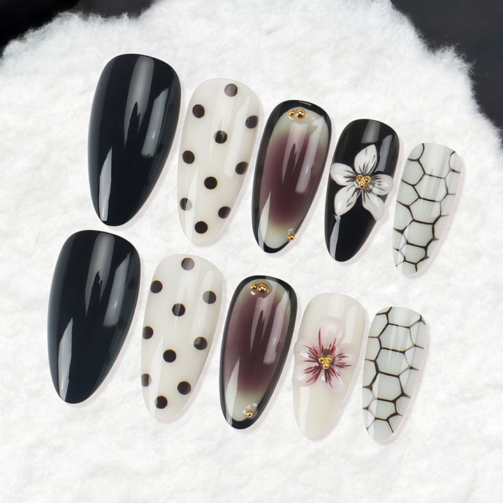 Künstlerisches Stiletto Press-On Nagelset mit Punkten und floralen Designs Karnz