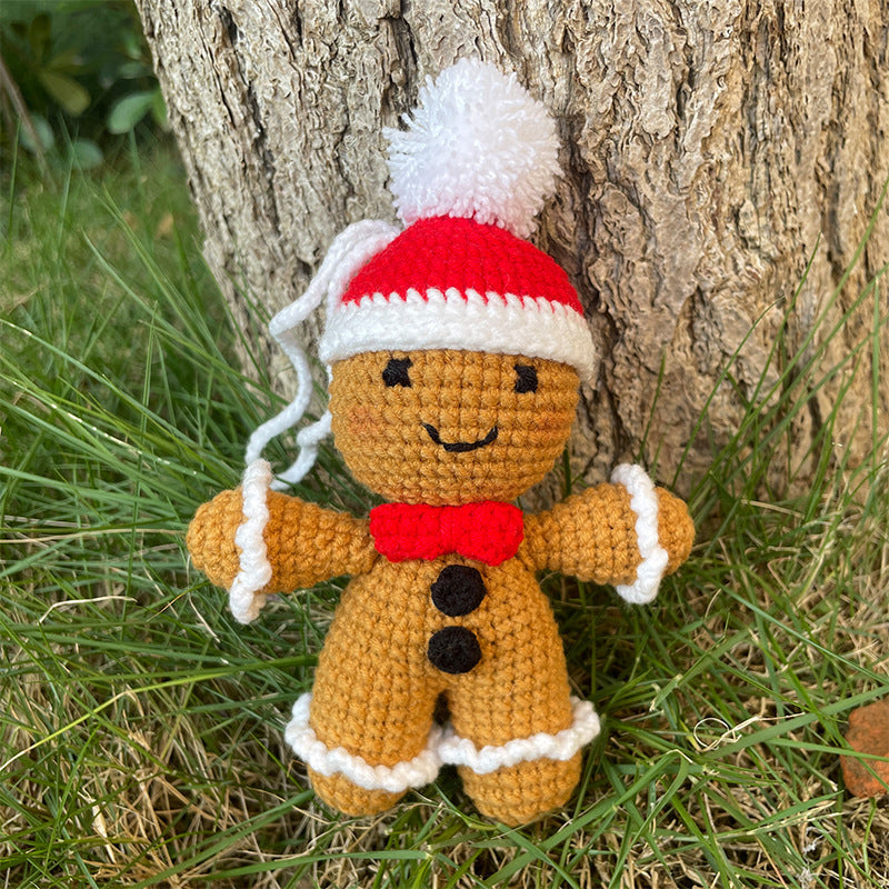 Plüschknuffel mit Weihnachtsmannhut und Schal