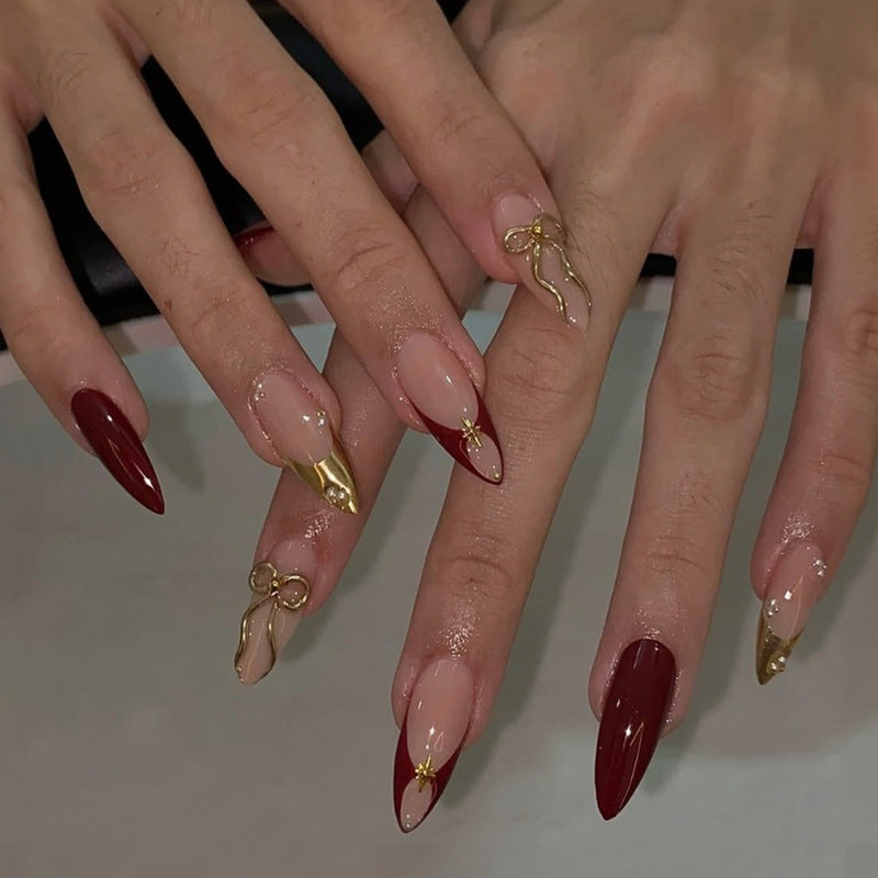 Kunstnagelset mit glamourösen Goldakzenten und eleganten Spitzen Karnz
