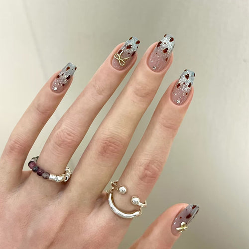Dekorativer Press-On-Nagelset mit Glitzer und floralen Akzenten Karnz