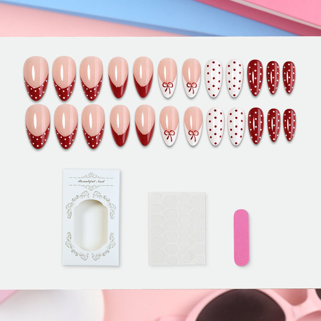 Kunstnagelset mit eleganten Schleifen- und Punkten Karnz
