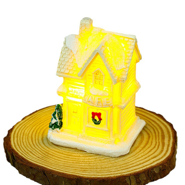Beleuchtetes Weihnachtsdorfhaus mit festlicher Dekoration Karnz