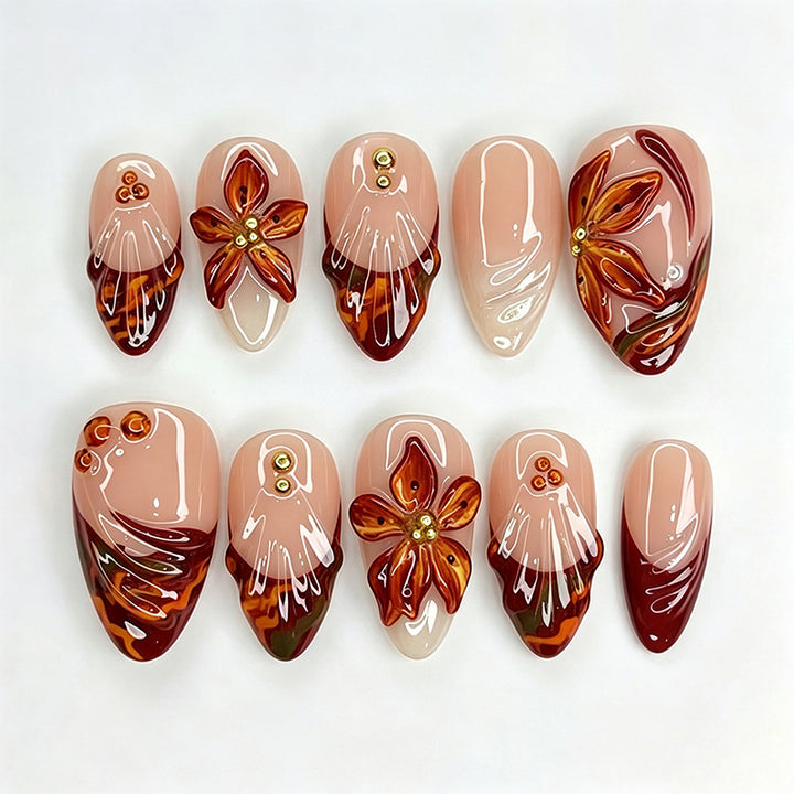 Kunstnagelset mit floralen 3D-Applikationen und eleganten Glitzelementen Karnz