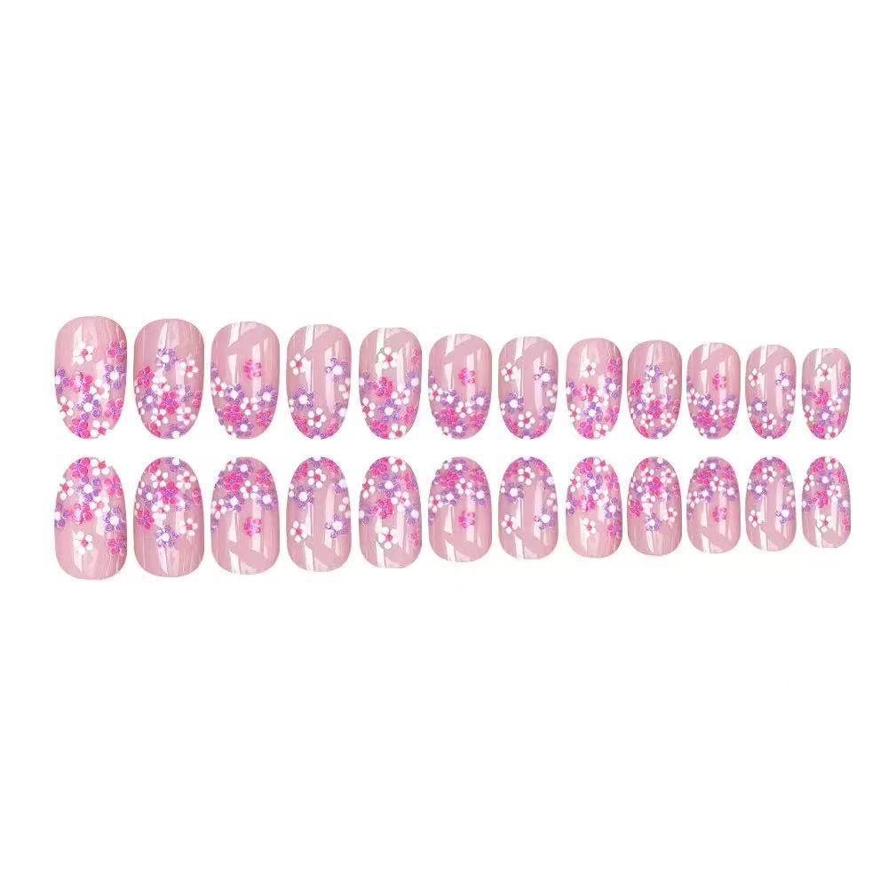 Kunstnagelset mit floralem Design und glitzernden Akzenten Karnz