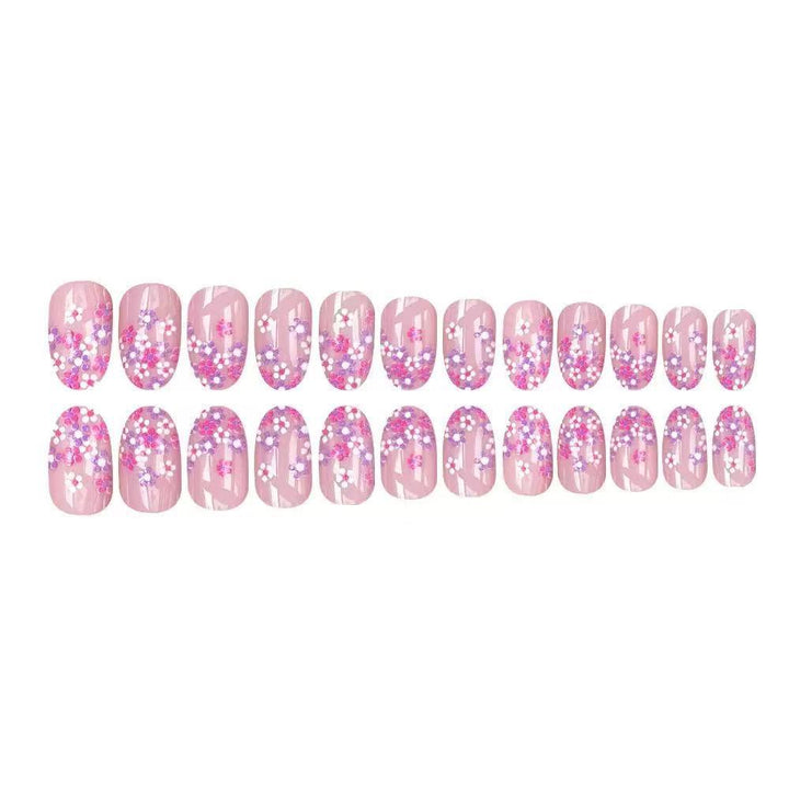 Kunstnagelset mit floralem Design und glitzernden Akzenten Karnz
