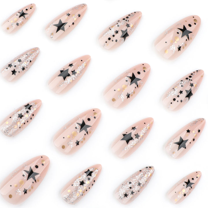 Kunstvolle Stiletto-Nägel mit Glitzer- und Sternenmotiv Karnz