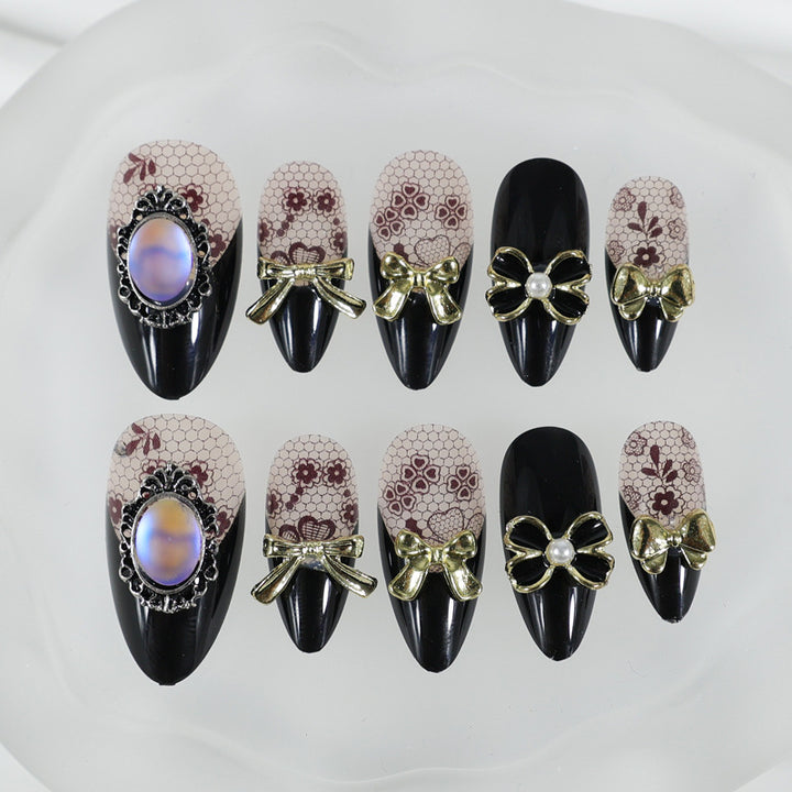 Kunstnagelset mit eleganten Punkt- und Schleifenverzierungen Karnz