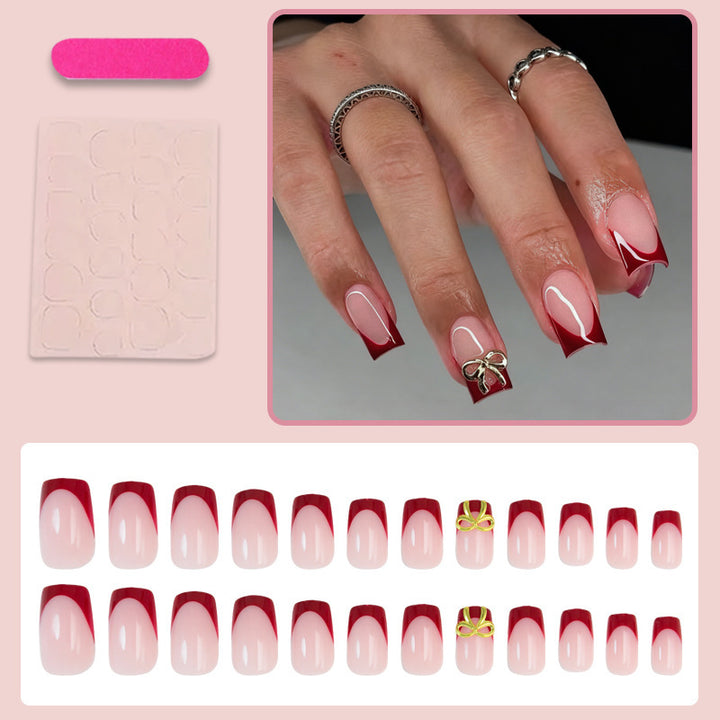Kunstnagelset mit eleganten roten Spitzen und raffinierten Schleifenverzierungen Karnz