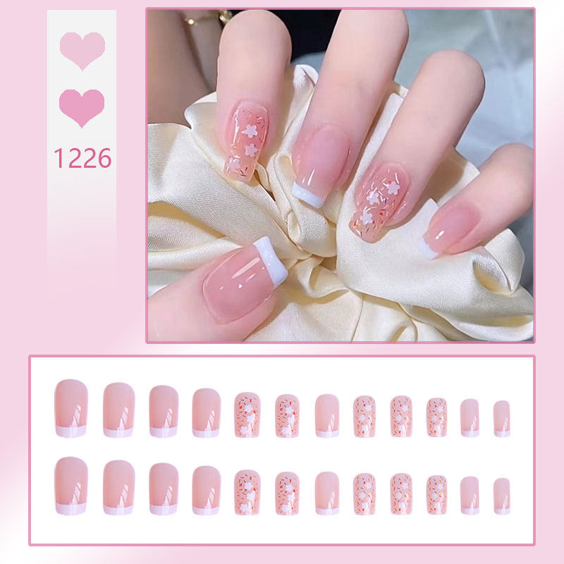 Kunstnagelset mit floralen Verzierungen und elegantem französischen Design Karnz