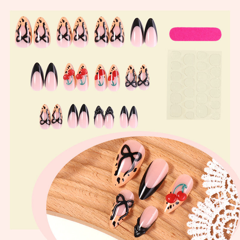 Kreatives Kunstnagelset mit stilvollen Schleifen- und Kirschmotiven Karnz