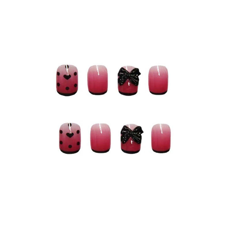 Themen Press-On Nagelset mit dekorativen Herz- und Schleifendesigns